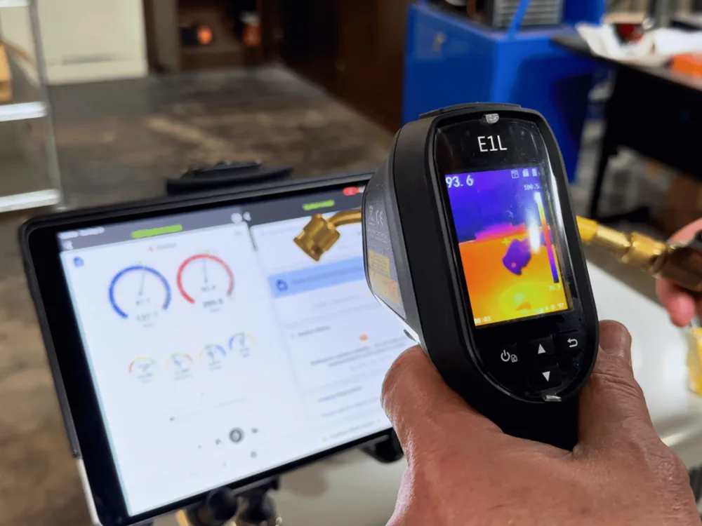 Technician using a thermal camera alongside the measureQuick diagnostics app in the field