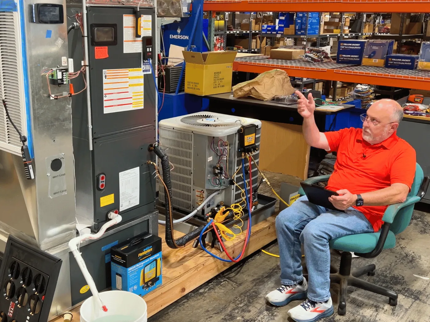 A measureQuick trainer teaching a class beside a live air handler and condenser training system